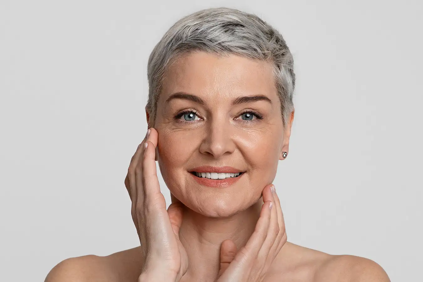Older woman touching her face and neck